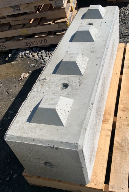 Close-up of a 400 x 400mm interlocking concrete block showing the raised locking studs