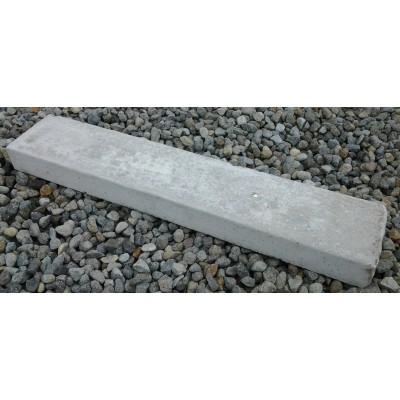 Rectangular concrete lawn edging strip on gravel